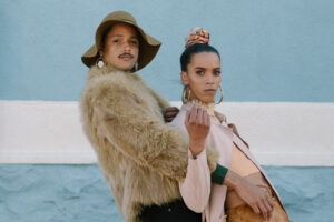 Two people in fur coats standing next to each other