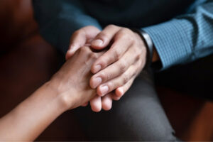 Two people's hands held together