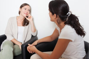 Two women sitting and talking to each other