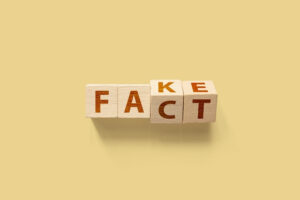 Tiles tilted towards the words FACT or FAKE