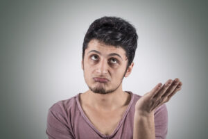 a person is holding their hand up in front of their face