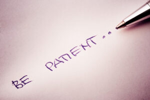  a pen writing 'Be patient'
