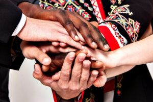 a group of people putting their hands together