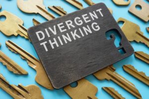 A black board with the writing 'divergent thinking'.