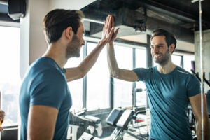 a man looking at himself while placing one hand on the mirror