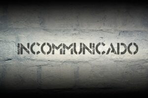 the word incommunicado written on a brick wall