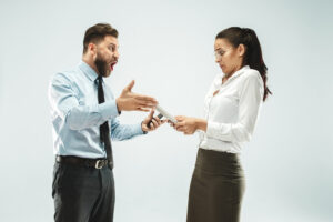 Two people in business attire are talking to each other