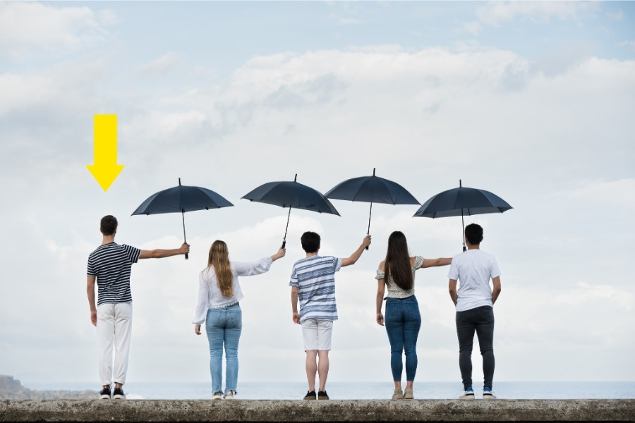 a group people holding out umbrellas
