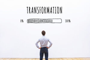A person standing in front of a transformation sign