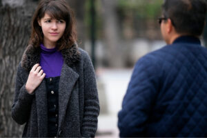a person is talking to another person on the street