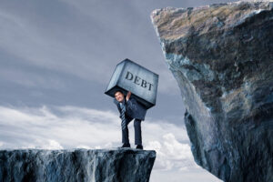a person in a suit carrying a box with the word debt on it