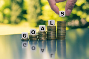 An image showin coins with the words GOALS writte on them.