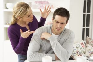 Two people arguing in front of a table
