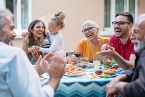 a group of people sitting around a table with food