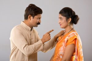 A person putting their finger on another person's neck.