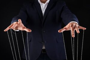 a person in a suit and tie is holding strings with their hands