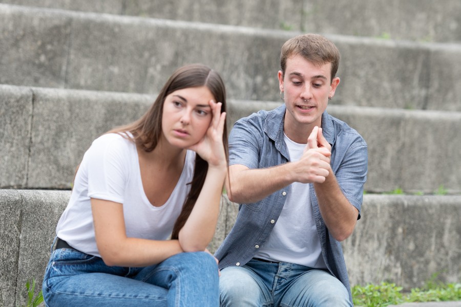Two people sitting on the steps of a building