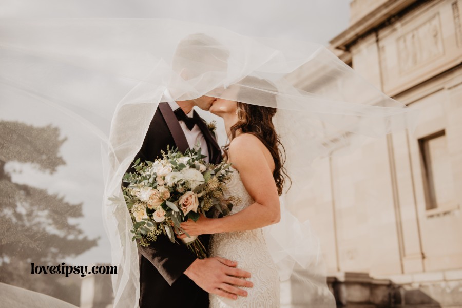 A newly wedded couple kissing.