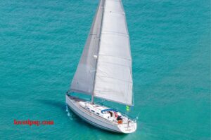 an aerial view of a sailboat in the ocean