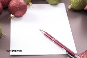 christmas ornaments on a table with a pen and paper