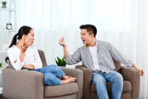 Two people sitting in chairs talking to each other