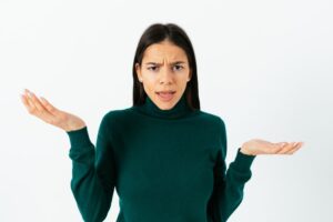 a person in a green sweater is holding their hands out