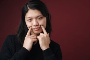 A person with their hands on their chin