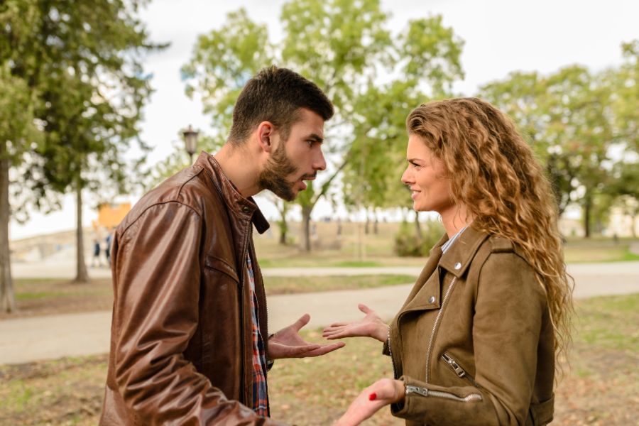 Two people are having an argument in the park.