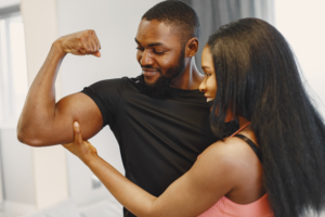 A man and woman flexing their muscles