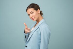 a person in a blue suit is giving the thumbs up sign