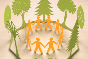 a group of people holding hands in a circle with trees in the background