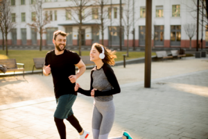 Two people jogging in a city park