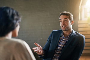 a person talking to another person in an office