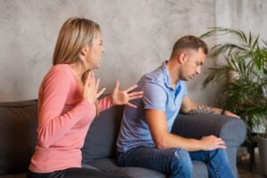 Two people arguing on a couch