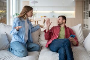 Two people sitting on a couch in a living room
