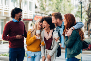 a group of friends laughing together in the street