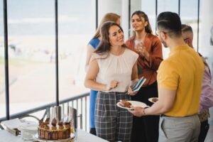 a group of people standing around a table with cake