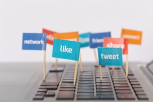  social media media icons attached to a laptop keypad
