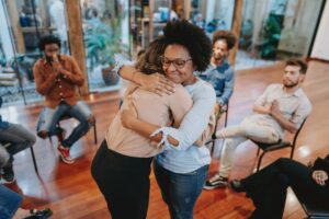 a person hugging another person in a group of people